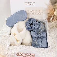 Step into a world of luxury with our Dusty Blue Fluffy Slippers Bridesmaid Gift Box. Designed for the modern bride who wants to spoil her bridal party, this exquisite gift box includes a sumptuous satin robe, a matching satin hair scrunchie and eye mask, a personalized champagne flute glass, and a pair of white personalized fluffy slippers. Indulge your bridesmaids in pure comfort and style as they prepare for your special day. These handmade slippers are not only cozy and soft but also customizable with each bridesmaid's name. It's the perfect keepsake to cherish long after the wedding bells have stopped ringing. But this gift box isn't just about pampering your bridal party - it's about creating beautiful memories. With color options to match your wedding theme, you can ensure that every Slippers Bridesmaid, Traditional Wedding Gifts, Boho Wedding Gifts, Personalized Champagne Flutes, Handmade Slippers, Fluffy Slippers, Bridesmaid Gift Boxes, Curated Gift Boxes, Flute Glass