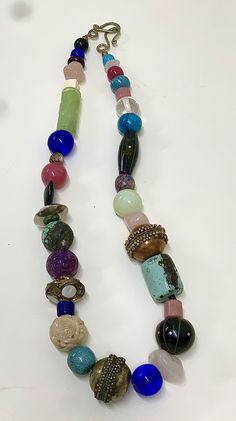 Huge, chunky, flashy assortment of precious & semiprecious elements. Includes natural hand carved jade, onyx, metal-inlaid opalite, turquoise, bone, obsidian, copper, Sterling, smoothed ancient Chinese glass, amethyst, rose quartz, and more. Purchased new from an artist's studio in the 1980s or 1990s, and never used; just stored in a jewelry box for decades. Perfect- like new. Sold as pictured. One Of A Kind Multicolor Eclectic Jewelry, Eclectic Multicolor One-of-a-kind Jewelry, Unique Czech Glass Beads With Natural Stones, Eclectic Large Beads Necklaces For Jewelry Making, Beaded Gemstones For Jewelry Making, Unique Beaded Gemstones For Jewelry Making, Unique Jade Beaded Necklaces With Gemstone Beads, Unique Jade Gemstone Beaded Necklaces, Spiritual Jade Jewelry With Large Beads