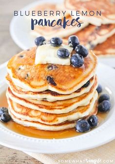 blueberry lemon pancakes on a white plate topped with butter and fresh blueberries are the perfect breakfast