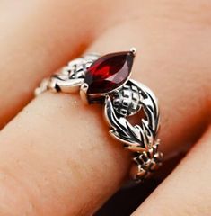 Elegant Vintage Estate Ring: This exquisite piece features a 1.12-carat marquise-cut natural garnet, delicately set in 925 solid sterling silver. The ring showcases a classic Scottish thistle design, symbolizing nobility and courage. Each ring is stamped with '925' to certify its authenticity as sterling silver. This timeless accessory is a testament to fine craftsmanship and enduring style, perfect for adding a touch of sophistication to any ensemble. Thistle Design, Estate Ring, Estate Rings, Scottish Thistle, Anniversary Present, Timeless Accessories, Pretty Rings, Marquise Cut, 925 Sterling Silver Ring