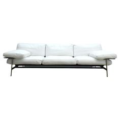 a white couch sitting on top of a metal frame