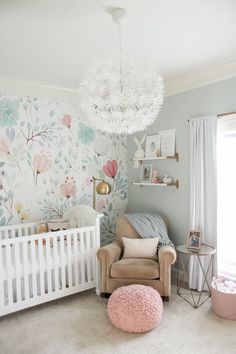 a baby's room with floral wallpaper and a white crib