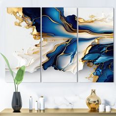 three abstract paintings on a wall next to a vase