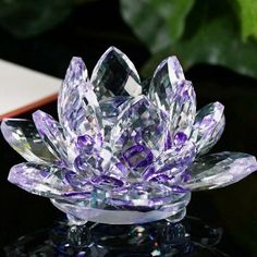 a crystal lotus flower sitting on top of a table