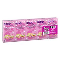 three packs of breasty conversation hearts with gummy bears in pink and white packaging