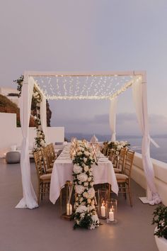 an outdoor dining area with candles and flowers