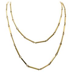 Beautifully 1980s 18 karat yellow gold long chain necklace. Measuring 39.5 inches in length it can be casually worn at full length or doubled up as a choker. Elongated rectangular bar links are flexibly connected to oval rings letting the bars turn and catch the light giving this necklace a charming lively effect. Luxury Double Strand Classic Chain Necklace, Luxury Yellow Gold Bar Necklace Fine Jewelry, Luxury Long Drop Necklaces With Adjustable Chain, Luxury Yellow Gold Chain Necklace With Rectangular Links, Luxury Everyday Necklace With Rectangular Links, Luxury Minimalist Necklace With Rectangular Links, Luxury Yellow Gold Bar Necklace With Adjustable Chain, Gold Long Chain, Long Chain Necklace