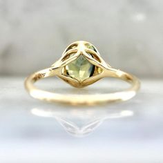 Why I Love It: This divine morsel features an ethereal 1.43 carat oval cut parti sapphire center with stunning hues of green, blue, and yellow. A perfectly matched pair of white round brilliant cut diamonds in the shoulders and delicious 14k Yellow Gold finish off this stunning engagement ring. Sits low and flush to the finger. The Details: 14k Yellow Gold 1.43 Carat Green Oval Cut Parti Sapphire Madagascar Origin .04 Carats Total of White Round Brilliant Cut Canadian Diamonds Current Ring Size Fine Jewelry Green Sapphire Ring With Rose Cut Diamonds, Green Sapphire Ring With Rose Cut Diamonds, Emerald Ring With Rose Cut Diamonds, Yellow Sapphire Solitaire Ring For Anniversary, Sapphire Birthstone Ring With Rose Cut Diamonds, Wedding Rings With Diamond Cut Yellow Sapphire, Elegant Yellow Sapphire Wedding Ring, Heirloom Green Sapphire Ring, Yellow Sapphire Ring With Round Cut