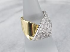 The simple wrap design of this ring is what saves it from being over the top, and keeps it the classy, sophisticated piece that it is. Rows of fine, bright, sparkling diamonds sit flush to the mounting, a perfect anniversary or cocktail piece!Metal: 18K Yellow and White GoldGem: 40 Diamonds totaling 2.15 Carats, SI1 in Clarity, H in ColorGem Measurements: 3.3 mm, RoundRing Size: 4.50Marks: "18K" Stamped on the inside band Modern Wide Band Diamond Ring For Wedding, Modern Yellow Gold Bypass Ring With Brilliant Cut, Elegant Wide Band Wedding Ring With Single Cut Diamonds, Modern Diamond Ring With Brilliant Cut And Wide Band, Modern Wide Band Diamond Ring With Brilliant Cut, Modern Brilliant Cut Wide Band Diamond Ring, Elegant Diamond White Bypass Ring With Tension Setting, Elegant Wide Band Ring With Tension Setting, Modern Wide Band Brilliant Cut Wedding Ring