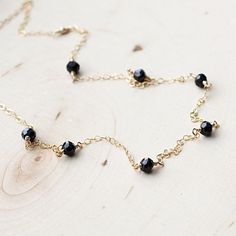 Scattered Spinel Gemstone NecklaceThe most tiny & dainty everyday necklace. Featuring seven tiny black spinel rondelles (~4mm each) that are hand wrapped to the most delicate & shimmering 14k gold fill chain. A gorgeous necklace that you will reach for everyday..Necklace measure 17 inches as pictured. Completed with a round spring clasp. ♥Your purchase will come thoughtfully packaged and ready for gift giving. If this purchase is a gift that we are shipping directly to the recipient, ple Gift Necklace With Black Spinel And Beads, Gift Black Spinel Necklace With Black Beads, Black Spinel Beaded Necklace For Gifts, Black Spinel Necklace With Black Beads For Gift, Minimalist Black Spinel Necklace As Gift, Delicate Black Necklace For Gift, Dainty Jewelry With Black Beads For Gifts, Dainty Jewelry With Black Beads As A Gift, Dainty Jewelry With Black Beads