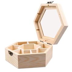 an open wooden box with compartments on the inside, and a mirror in the middle