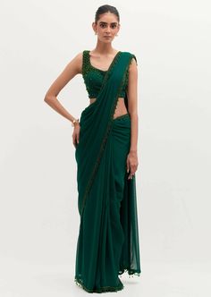 The signature and bestseller emerald masoom sari! Embroidered in pearls all over, with a featured embroidered cape. Traditional Embroidered Pre-draped Saree With Cape Sleeves, Green Blouse Piece For Evening With Traditional Drape, Traditional Pre-draped Saree With Pearl Embroidery For Evening, Green Blouse Piece With Dupatta For Evening, Green Cutdana Pre-draped Saree For Evening, Green Silk Saree For Evening, Traditional Pearl Embroidered Pre-draped Saree For Festive Occasions, Green Silk Evening Saree, Evening Green Silk Saree