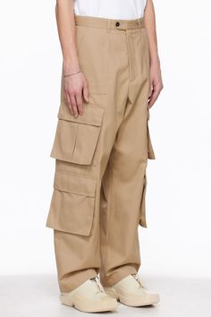 Polyester- and cotton-blend gabardine cargo pants. · Paneled construction · Belt loops · Four-pocket styling · Zip-fly · Bellows pockets at outseams · Horn hardware Supplier color: Beige Beige Utility Pants With Patch Pockets, Khaki Work Pants With Cargo Pockets, Beige Utility Pants With Flap Pockets, Khaki Cargo Work Pants, Baggy Khaki Work Pants With Multiple Pockets, Khaki Cargo Trousers For Work, Baggy Tapered Leg Work Pants With Cargo Pockets, Baggy Work Pants With Cargo Pockets And Tapered Leg, Khaki Work Pants With Multiple Pockets