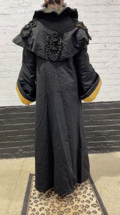 "Victorian black and gold wool coat w/ gold overlay panels ending in tassels, corded embellishment on each sleeve and continuing on to the middle back, large bell sleeves, 1 pocket on the inside, 4 hook and eyes, gold brocade lining w/ printed flowers, collar is gold and covered in a sheer fabric, shawl style overlay. Size M, Shoulders 18\", length 54\", sleeve (length) 24\", sleeve (width) 14.5\" Great condition! Etsy Shipping -Vintage and pre-owned items may have signs of wear and use and are Printed Flowers, Flowy Jumpsuit, Shawl Style, Gold Brocade, Gold Overlay, Norma Kamali, Horizontal Stripes, Sheer Fabric, Etsy Shipping