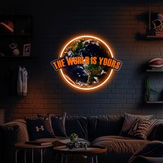 the world is yours neon sign mounted on a brick wall above a couch in a living room