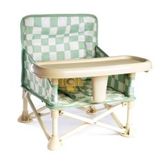 a green and white checkered highchair with an infant's seat on it