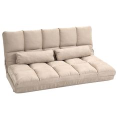 a beige couch with pillows on the back and arms, sitting in front of a white background