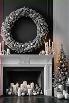 a christmas mantle with candles and wreath on it