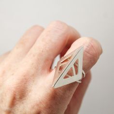 Featuring an abstract design inspired by a bird’s beak, this sterling silver ring is created from hand sawn sterling silver sheet, filed and refined into shape, with striations from the file left for a subtle stylistic texture. Overall design set on a twin hammered ring base. Polished to a high shine. Geometric Silver Ring As Gift, Silver Geometric Rings As Gifts, Silver Geometric Ring As Gift, Silver Geometric Ring Gift, Silver Geometric Ring For Gift, Unique Silver Geometric Rings, Geometric Sterling Silver Ring, Silver Geometric Sterling Silver Ring, Sterling Silver Geometric Ring In Silver