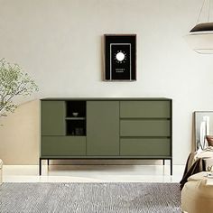 a living room with a large green cabinet in the center and a white rug on the floor