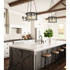 a kitchen island with four stools and two lights hanging from it's ceiling