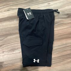 Ua Pennant Woven Cargo Pant Nwt Black Yxs Outdoor Black Cargo Pants With Built-in Shorts, Black Cargo Pants With Built-in Shorts For Outdoor, Sporty Short Cargo Pants For Sports, Short Sports Pants With Side Pockets, Under Armour Bottoms With Pockets, Under Armour Black Moisture-wicking Bottoms, Under Armour Casual Streetwear Pants, Sporty Black Pants With Built-in Shorts, Under Armour Black Functional Bottoms