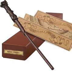 two harry potter wands are sitting next to each other on top of a box