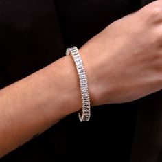 Introducing the Diamond Baguette Tennis Bracelet in White Gold- 6mm, an elevated twist on your classic tennis bracelet. This piece is sleek and sophisticated, featuring hand-set baguette stones, plated in 14k White Gold, and finished with our signature GLD clasp. Upgrade your fit and pair it with the Diamond Baguette Tennis Necklace for a matching set that is guaranteed to shine! This product is guaranteed for life – GLD will repair or replace the item should you experience any defects in crafts Elegant Rectangular Tennis Bracelet With Baguette Diamonds, Classic Baguette Diamond Bracelet, Classic Baguette Cut Tennis Bracelet, Formal Baguette Cubic Zirconia Tennis Bracelet, Elegant Baguette Cubic Zirconia Tennis Bracelet, Elegant Cubic Zirconia Baguette Tennis Bracelet, Diamond Baguette, Phone Chain, Baguette Cut Diamond