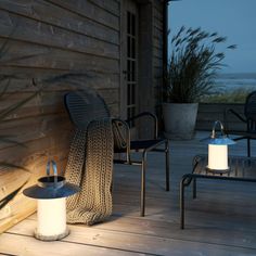 two chairs and a table on a wooden deck