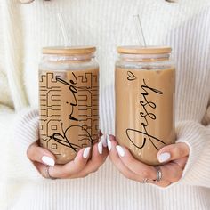 two women holding coffee mugs with writing on them