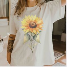 Sunflower Shirt, Flower Shirt, Spring Sunflower tshirt, Garden Shirt, Sunflowers Gift for her, Wildflower tee, Flower Print Tee size S-4X Step into spring with our vibrant unisex sunflower shirt, perfect for garden lovers and fashion enthusiasts alike! Made from eco-friendly, soft, breathable cotton, this tee boasts a bold, eye-catching flower print design. Ideal for gardening, casual wear, or festive occasions, it's a versatile addition to any wardrobe. Available in multiple sizes, this sunflow Yellow T-shirt With Sunflower Design For Spring, Cotton Crew Neck T-shirt With Sunflower Design, White Daisy Print T-shirt For Summer, Cotton Short Sleeve T-shirt With Sunflower Print, Summer Floral Print Top, Casual White T-shirt With Sunflower Design, White Botanical Shirt For Summer, White T-shirt With Sunflower Print For Spring, White Summer Top With Sunflower Print