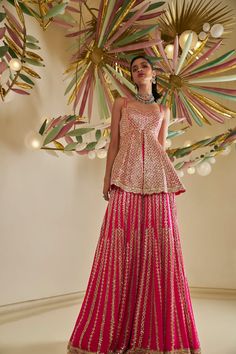 This sharara set features intricate gota patti embroidery on a fuchsia georgette base. The peplum top is paired with a flowy sharara and a four-sided embroidered dupatta.From Seema Gujral's Fiori - the sharara edit collection. DELIVERY TIMEPlease allow 8-12 weeks for your outfit to arrive. FABRIC DETAILSGeorgette Professional cleaning only. Mehendi Outfits Sisters, Gota Patti Lehenga, Gota Patti Embroidery, Pink Sharara, Mehendi Outfits, Bridesmaid Saree, Royalty Aesthetic, Indian Wedding Wear, Embroidered Dupatta