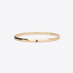 The Milestone bangle with the addition of one bezel set birthstone. A beautiful piece to add to your stack for a celebration or to represent children or grandchildren. A 4mm solid 14k gold half round bangle with a flat interior.Stone Details: 2.5mm natural birthstones totaling approximately .1tcw The stones in our jewelry are always natural/earth mined, with the exception of Alexandrite, which is lab grown. We source lab grown Alexandrite to ensure high quality and consistent and fair pricing. T 14k Gold Birthstone Bracelets, 14k Gold Stackable Bracelets With Round Band, Stackable 14k Gold Bracelet With Round Band, Stackable 14k Gold Bracelets With Round Band, Fine Jewelry Round Bangle For Everyday, 14k Gold Wedding Bangle With Single Diamond, Yellow Gold Bangle With Single Diamond As Gift, Yellow Gold Bangle With Single Diamond, Fine Jewelry Bangle With Single Diamond