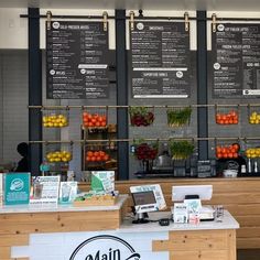 the front counter of a coffee shop with menus on the wall