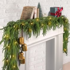 a mantel with christmas decorations and bells on it