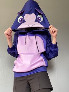 ● Fabric: 95% polyester and 5% spandex ● Regular fit ● Long sleeve, decorative ears, kangaroo pocket ● Care Instruction: machine wash cold with similar colors, do not bleach, tumble dry low, do not iron, do not dry clean. Blue Casual Hoodie For Cosplay, Casual Blue Hoodie For Cosplay, Purple Long Sleeve Hoodie With Kangaroo Pocket, Purple Hooded Hoodie With Pockets, Purple Long Sleeve Sweatshirt With Kangaroo Pocket, Purple Hooded Hoodie With Kangaroo Pocket, Stretch Fleece Sweatshirt With Kangaroo Pocket, Blue Long Sleeve Hoodie For Cosplay, Fitted Casual Hoodie For Cosplay