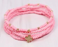 This pink cross bracelet stack features 5 pastel pink beaded bracelets adorned with a beautiful gold-colored cross. Perfect for spring and summer, this stack adds a touch of femininity to any outfit. Complete your look with this delicate and charming accessory. Pink Beaded Bracelets For Spring, Adjustable Pink Cross Bracelet, Pink Adjustable Cross-shaped Bracelets, Pink Beaded Bracelets, Dress Bar, Spring Essentials, Pink Cross, Cross Bracelet, Bar Accessories