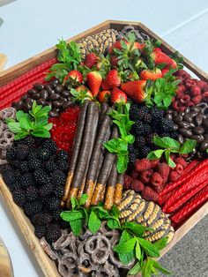 a wooden box filled with lots of different types of fruits and vegetables on top of a table