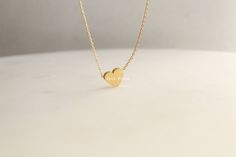 "Add a touch of elegance and sophistication to your jewelry collection with this beautiful brushed heart pendant necklace. Made with 18k gold dipping, this necklace features a unique and striking heart charm with a brushed finish that gives it a beautiful, soft texture. The heart is a symbol of love, affection, and connection, making this necklace a great gift for yourself or a loved one. The 16 inch chain is delicate and understated, allowing the heart charm to be the focal point of the piece. Minimalist Wedding Jewelry With Heart Charm, Minimalist Heart Charm Jewelry, Minimalist Jewelry With Heart Charm, Minimalist Heart Pendant Jewelry For Wedding, Minimalist Tarnish Resistant 14k Gold Heart Necklace, Minimalist Heart Charm Necklace For Wedding, Minimalist Double Heart Jewelry Gift For Her, Minimalist Heart Pendant Necklace For Anniversary, Minimalist Double Heart Jewelry As A Gift For Her