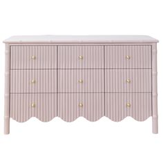 a pink dresser with gold knobs on the top and bottom drawers, against a white background