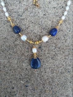 Necklace is 20 in, and is made with lapis lazuli stone, freshwater pearls, and Gold plated findings. Lovely lapis teardrops throughout! This set can come with earrings! Blue Briolette Pearl Necklace For Gift, Gift Blue Briolette Pearl Necklace, Blue Teardrop Pearl Drop Jewelry, Handmade Blue Teardrop Drop Necklace, Crystal Necklaces, Lapis Lazuli Stone, Teardrop Necklace, Bead Stringing, Silver Chain Necklace