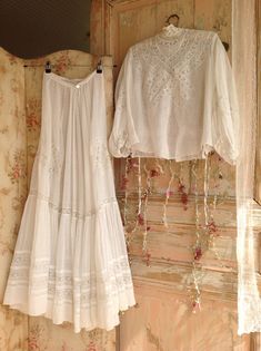 two white dresses hanging on the wall