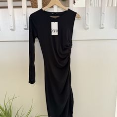 Elevate Your Wardrobe With This Brand New Zara Midi Dress In Classic Black, Complete With Tags. This Elegant Dress Features A Unique One-Sleeve Design, Adding A Contemporary Edge. The Side Tie And Ruched Detail Create A Flattering Silhouette, While The Asymmetrical Cut Adds A Modern Touch. Perfect For Formal Events Or A Night Out, This Dress Combines Style And Sophistication. Make A Bold Fashion Statement With This Versatile Piece That Embodies Zara's Signature Blend Of Trendy And Timeless. Black Draped Midi Dress For Fall, Black Ruched Asymmetrical Dress, Chic Black Asymmetrical Ruched Dress, Chic Black Ruched Asymmetrical Dress, Black Asymmetrical Ruched Dress For Spring, Black Ruched Asymmetrical Dress For Spring, Asymetrical Dress, Zara Midi Dress, Zara New