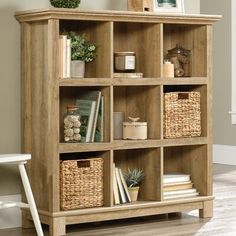 a wooden bookcase with baskets and books on top of it in a living room