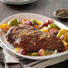 a white plate topped with meat and vegetables