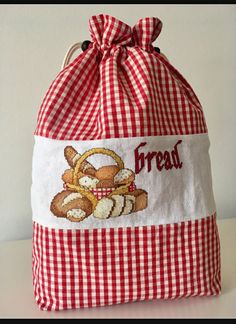 a red and white gingham bag with a teddy bear on it