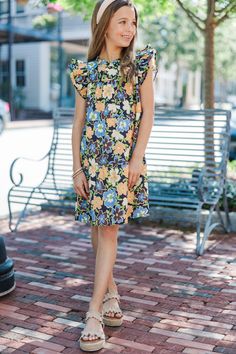 This dress is just precious! The floral print and those colors are absolutely perfect for the upcoming spring season! The little ruffled detailing around the neckline and sleeves are so girly and cute! Round neckline Short ruffled sleeves Button keyhole back Floral print Babydoll cut Runs SHORT. We recommend sizing up one size for extra length. No stretch Morgan is wearing the small. Bold Outfits, Floral Babydoll Dress, Floral Cocktail Dress, Black Tie Dress, Girl's Back, Cute Rompers, Girls Sweet, Ruffled Sleeves, Romper With Skirt