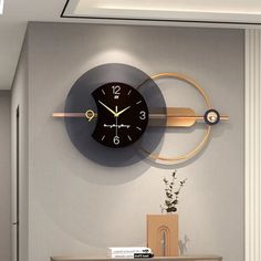 a clock that is on the side of a wall next to a table and chair