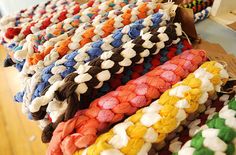 many different colored knitted items are on display