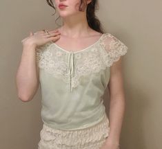 This was a vintage romantic nightgown cut into a flowing cropped tank top. It is darling and classy with slightly off shoulder lace trim, but casual with a loose shape. It could be worn as nightwear or as a blouse. Feminine Lace Patchwork Camisole, Delicate Sleeveless Summer Tops, Spring Flirty Lace Tops, Spring Coquette Lace Top, Delicate Lace Summer Tops, Vintage Lace Trim Camisole For Spring, Feminine Summer Lace Patchwork Camisole, Feminine Summer Camisole With Lace Patchwork, Feminine Lace Patchwork Camisole For Summer